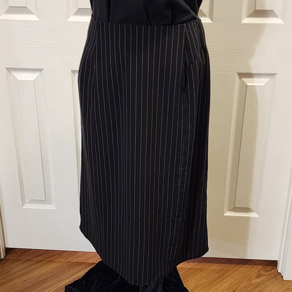 Black pinstriped skirt with kick-pleat button details on the back hem